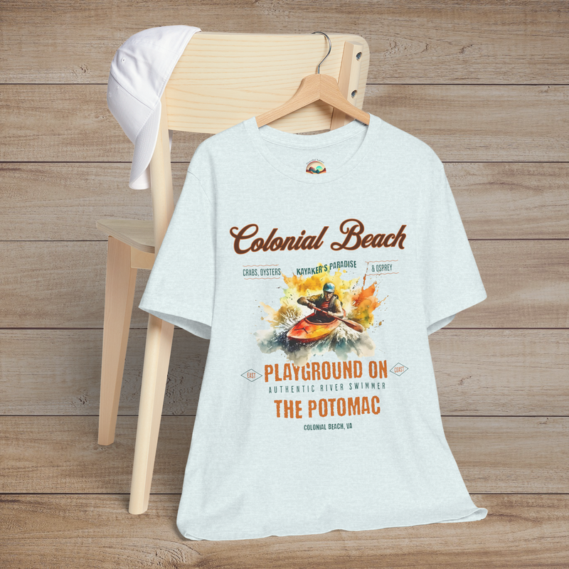 Colonial Beach Premium T-Shirt Playground on the Potomac design laid out on a heather ice blue t-shirt, resting on a chair with a white cap, perfect for outdoor and kayaking fans