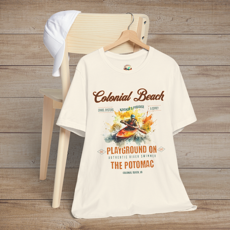 Colonial Beach Premium T-Shirt Playground on the Potomac design featured on a natural color t-shirt, styled against a wood backdrop with a casual cap for coastal aesthetics