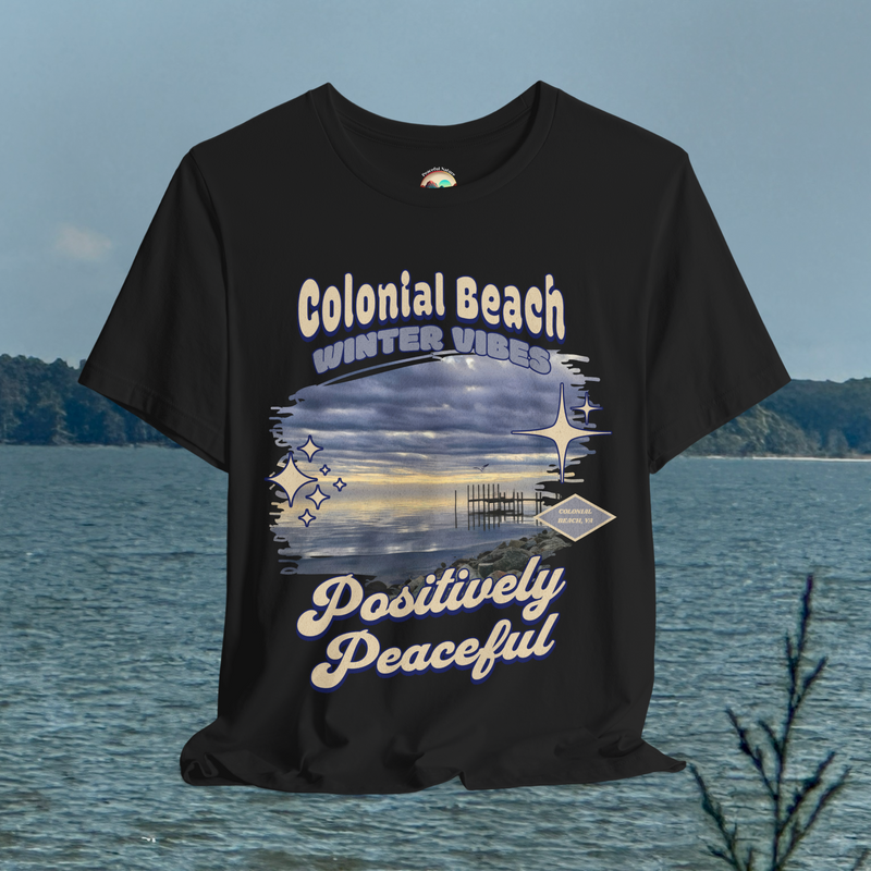 Flatlay of Colonial Beach Winter Vibes Premium T-Shirt in black color displayed against an ocean background
