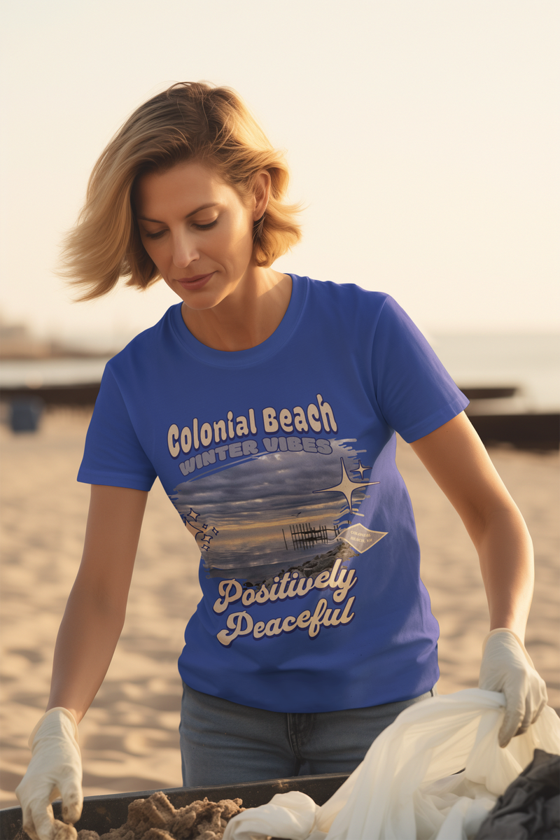 woman wearing colonial beach winter vibes royal blue premium t-shirt during beach cleanup