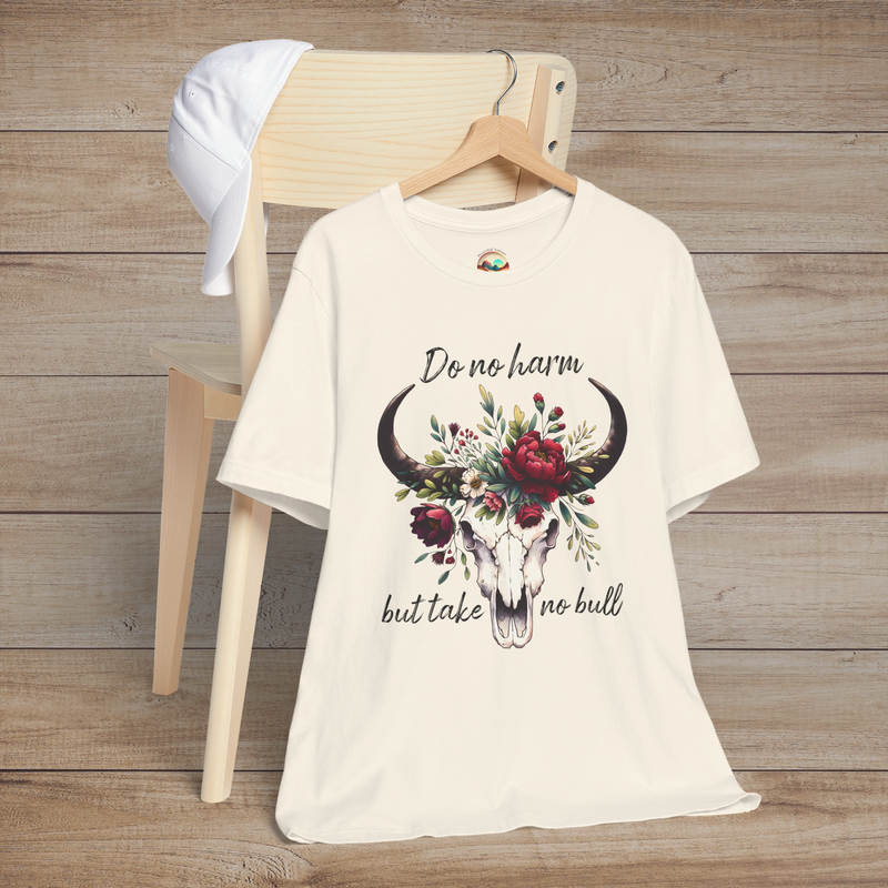 Flat lay of "Do No Harm But Take No Bull" t-shirt in natural with bull skull and floral crown