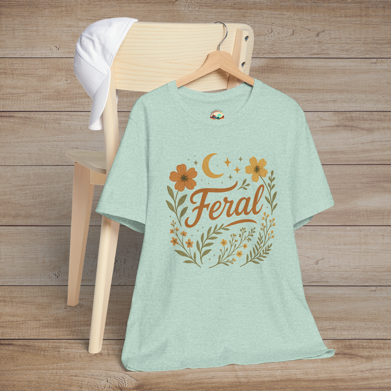 Feral t-shirt in Heather Prism Mint with floral and moon design in elegant calligraphy, displayed on a chair with a cap