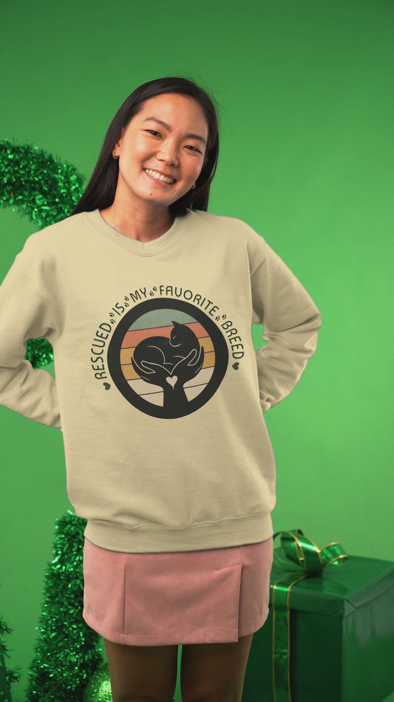Video of woman wearing the Rescued Is My Favorite Breed sweatshirt at Christmas time.