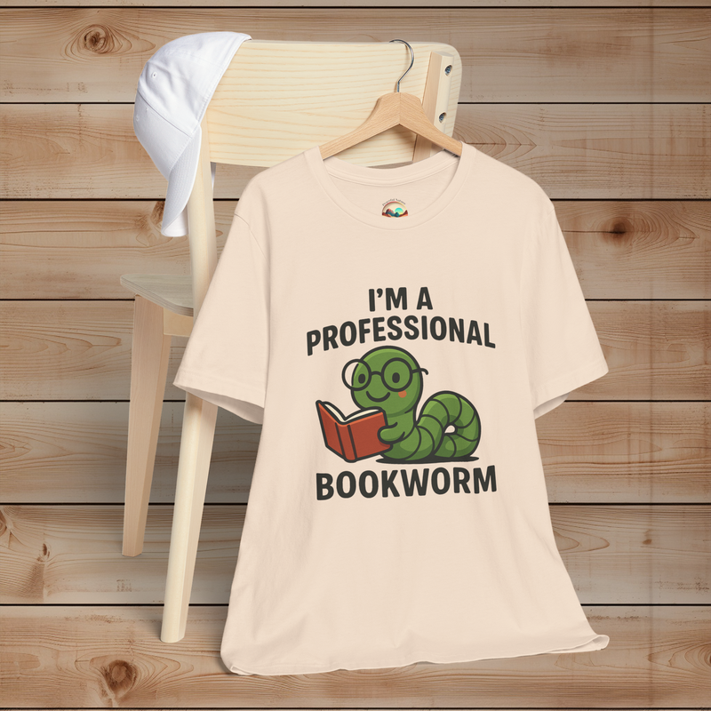Soft cream t-shirt with a graphic and text 'I'm a Professional Bookworm' on a wooden background