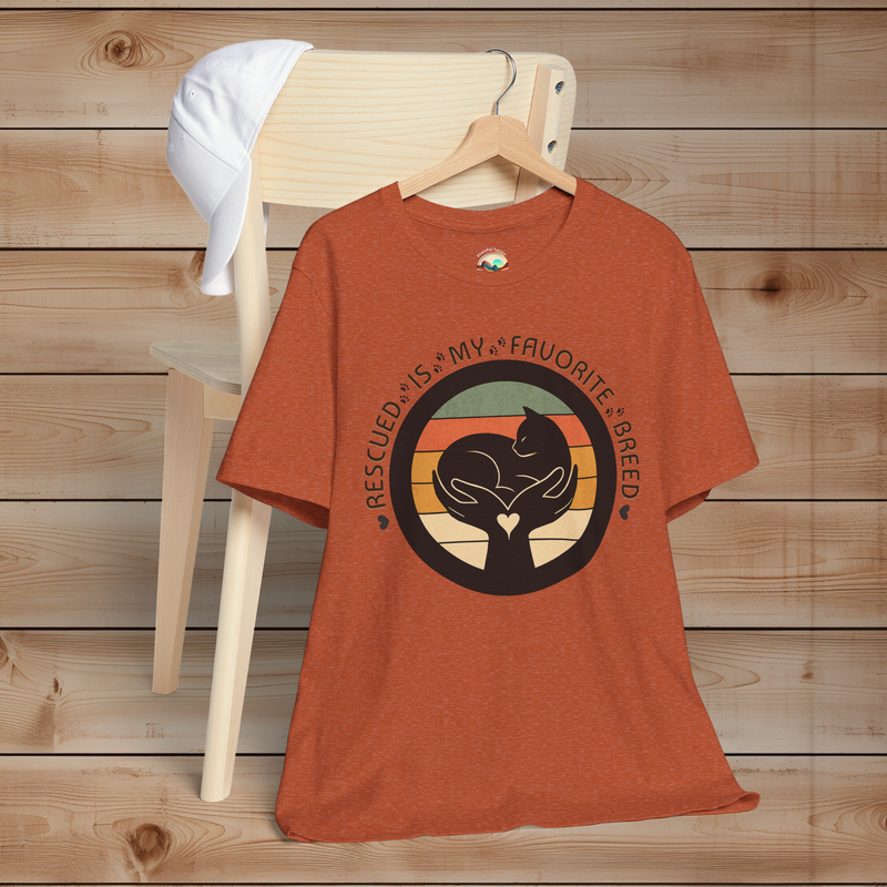 Heather Autumn cat rescue T-shirt – ‘Rescued Is My Favorite Breed’ graphic with vintage sunset circle and minimalist cat silhouette.