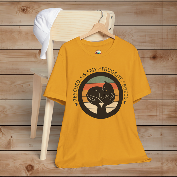 Mustard yellow ‘Rescued Is My Favorite Breed’ animal rescue shirt – cat silhouette in hands, heart-centered retro artwork.