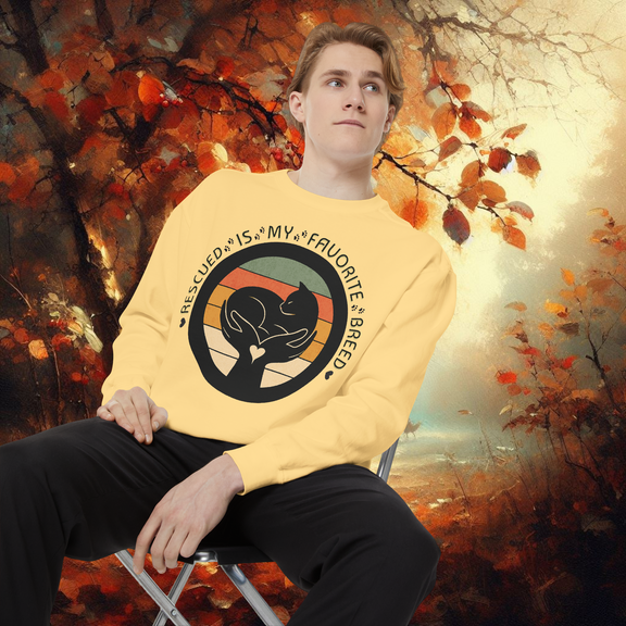 Model wearing butter yellow Comfort Colors 1566 sweatshirt featuring โRescued Is My Favorite Breedโ design, warm autumn forest backdrop