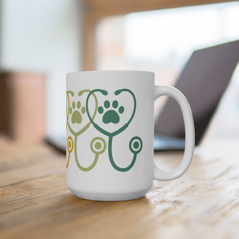 15 oz ceramic mug on desk with green paw prints and stethoscope shapes – right context