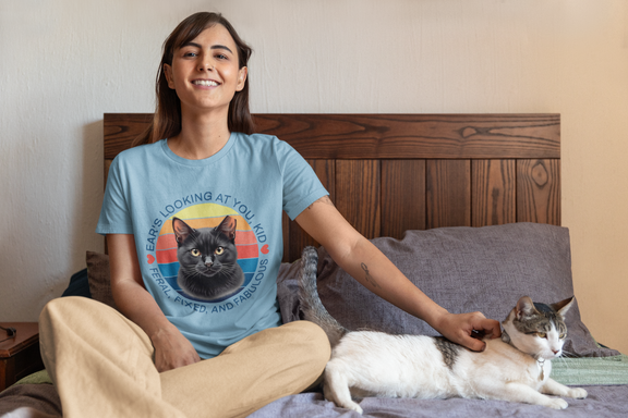 Woman wearing ocean blue Ear’s Looking at You Kid TNR cat shirt with retro ear-tipped black cat design, Bella Canvas 3001