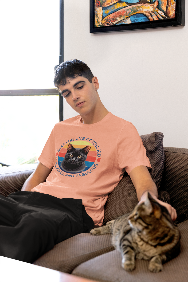 Man wearing sunset-colored Ear’s Looking at You Kid TNR cat shirt with retro ear-tipped black cat design, Bella Canvas 3001