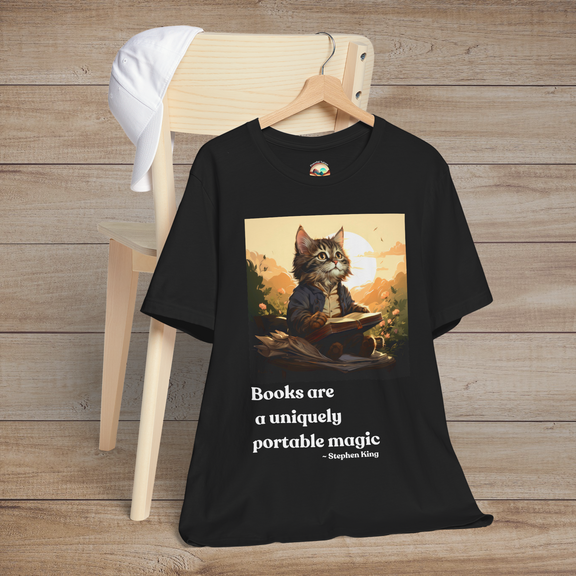 Books Are a Uniquely Portable Magic cat t-shirt in black displayed on a wooden chair