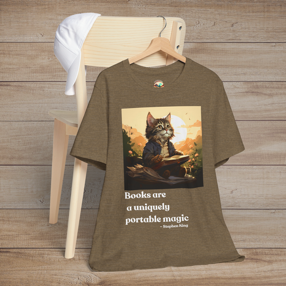 Books Are a Uniquely Portable Magic cat t-shirt in heather olive displayed on a wooden chair