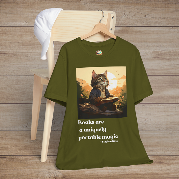 Books Are a Uniquely Portable Magic cat t-shirt in olive green displayed on a wooden chair