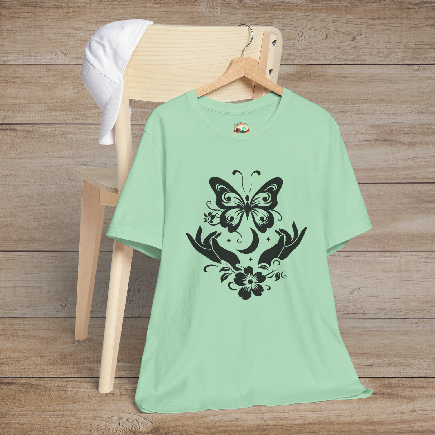 Butterfly Release minimalist t-shirt in mint green with black butterfly and floral artwork