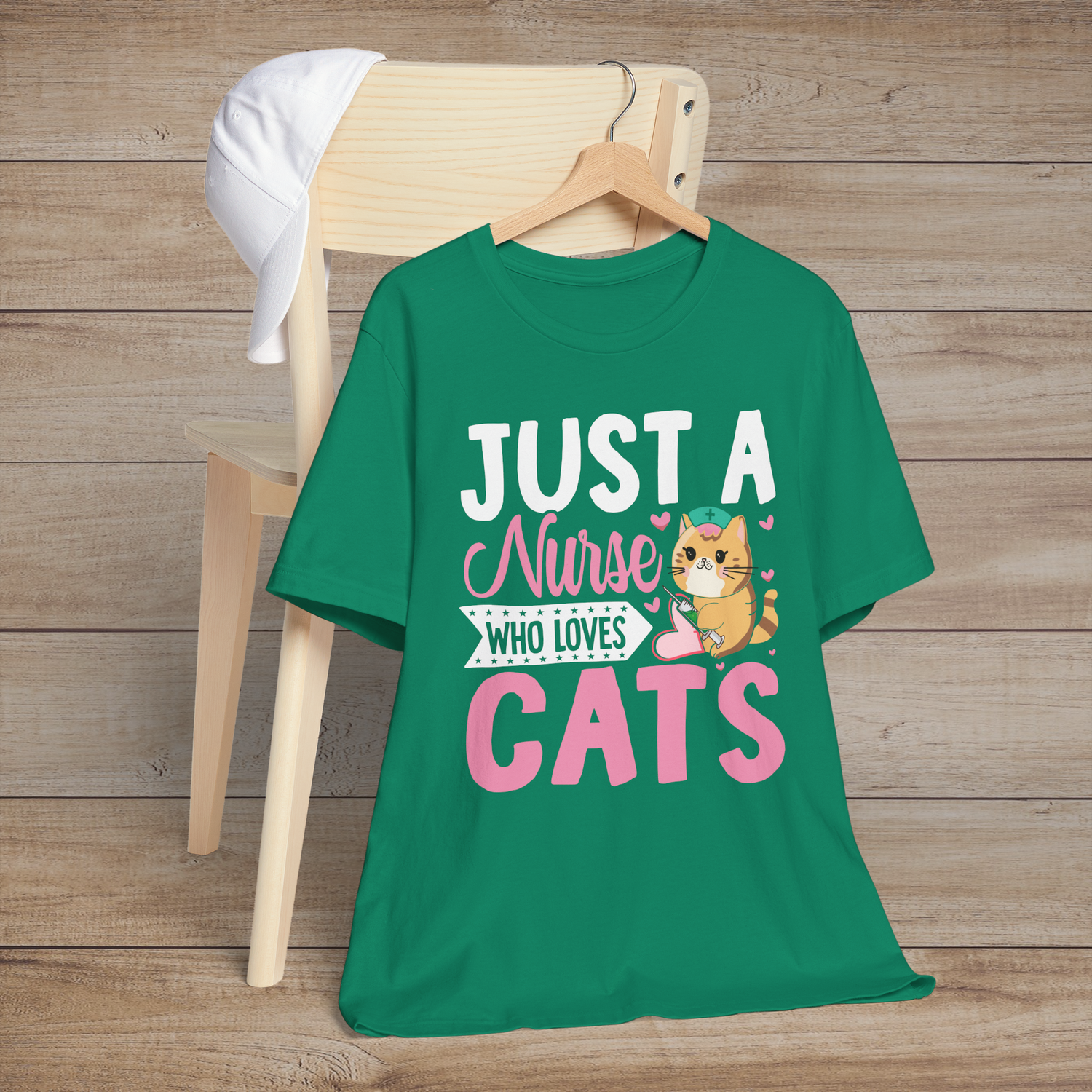 Kelly green t-shirt showcasing a charming orange cat in a nurse’s cap holding a shot needle with the text Just a Nurse Who Loves Cats