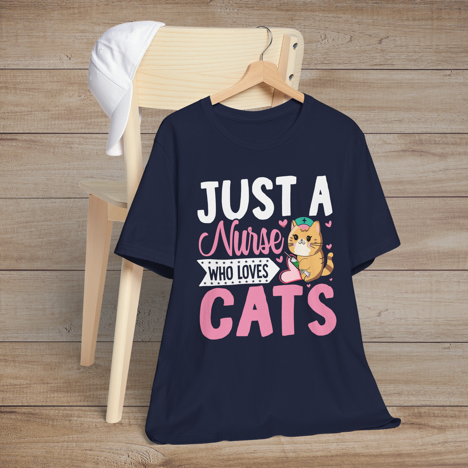 Navy blue t-shirt with a playful orange cartoon cat nurse and the fun phrase Just a Nurse Who Loves Cats