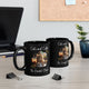 Two black mugs with an orange cat and "Cats and Coffee: The Purrfect Blend" design, displayed on an office desk. Fun coffee mugs for cat lovers, available in 11oz and 15oz sizes