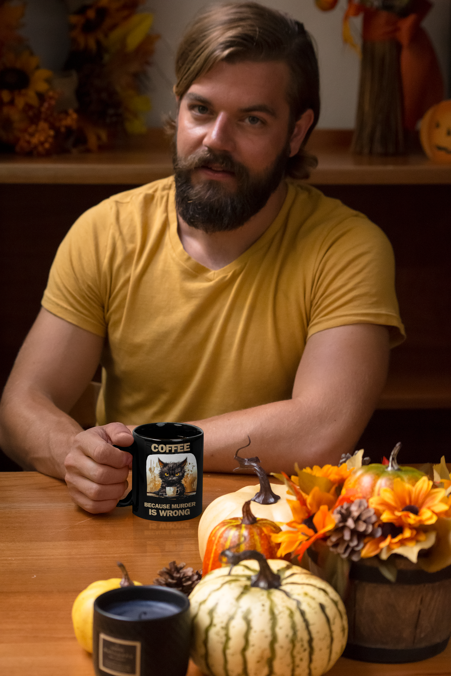 Man  displaying 11 oz black mug, left view, with angry cat design and funny "Coffee Because Murder Is Wrong" saying