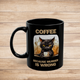 Black 11 oz coffee mug featuring grumpy cat artwork with humorous "Coffee Because Murder Is Wrong" slogan on rustic wood surface