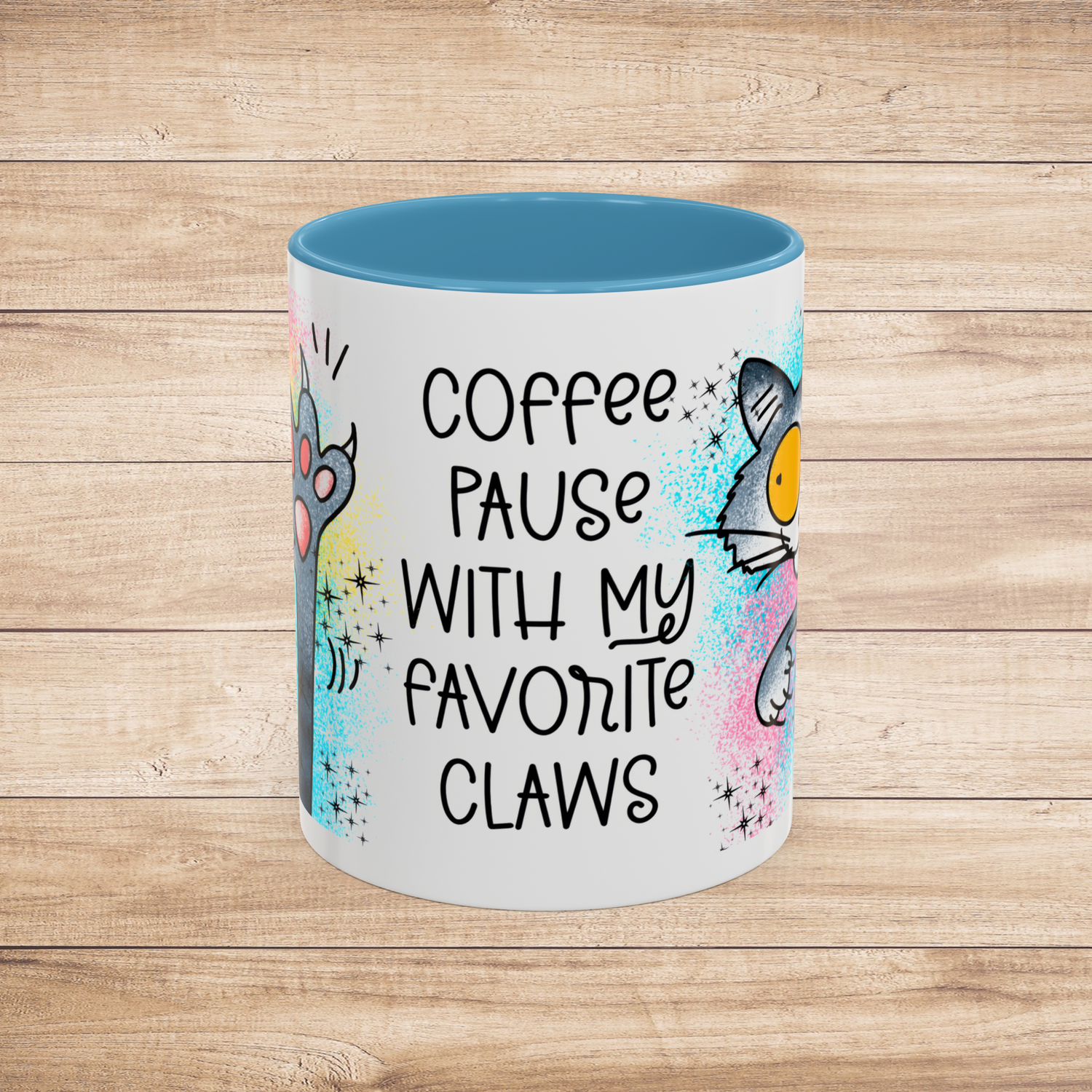Front view of the 11 oz Coffee Pause with My Favorite Claws Mug with cheerful light blue interior trim, featuring whimsical cartoon art of a playful cat and paw, alongside the humorous quote 'Coffee pause with my favorite claws.' Ideal mug for cat lovers