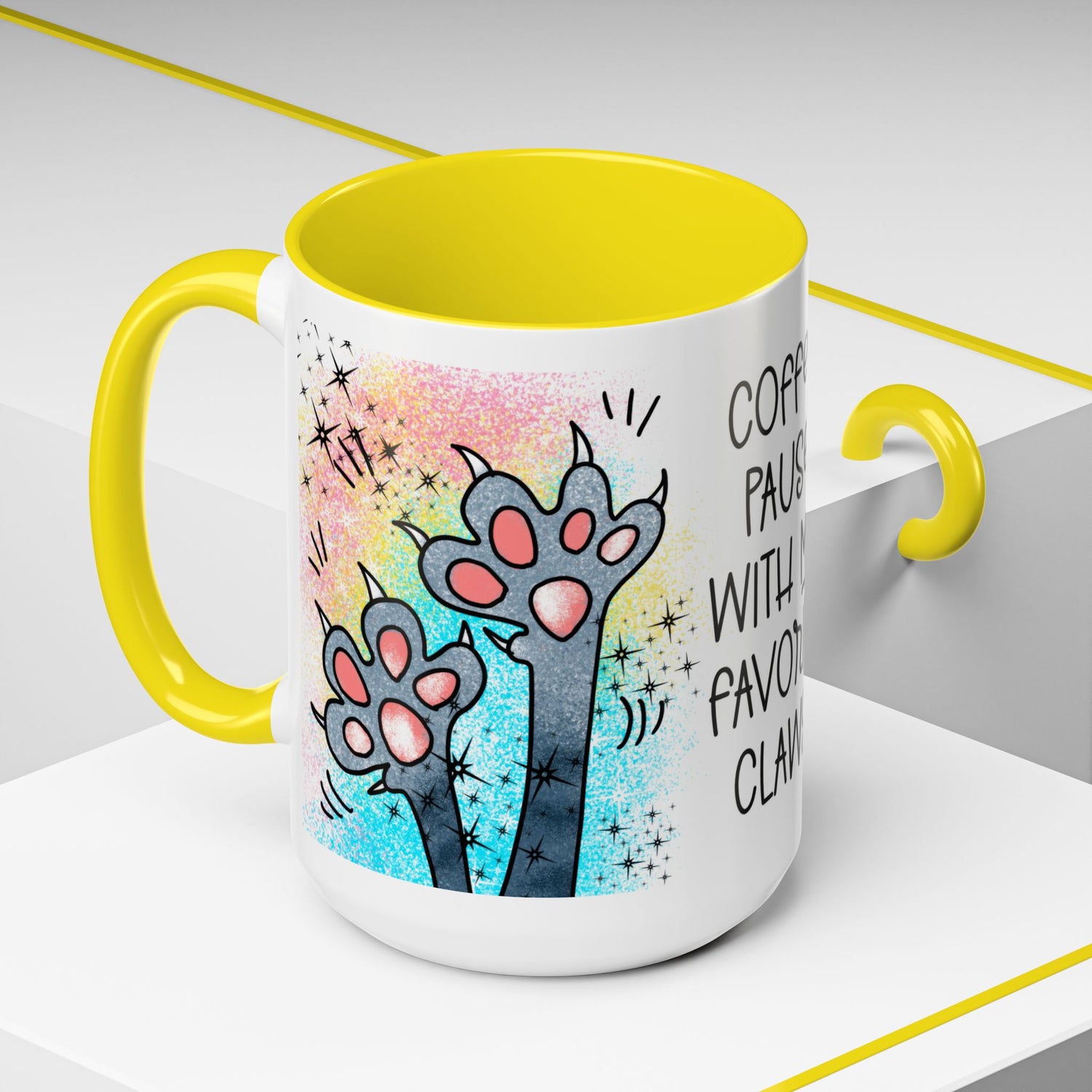 Left-side view of the 15 oz Coffee Pause with My Favorite Claws Mug, accented with vibrant yellow handle and interior. Features a fun cartoon illustration of two cheeky cat paws with claws extended, complementing the amusing caption 'Coffee pause with my favorite claws.' Perfect humorous mug for coffee-loving cat fans