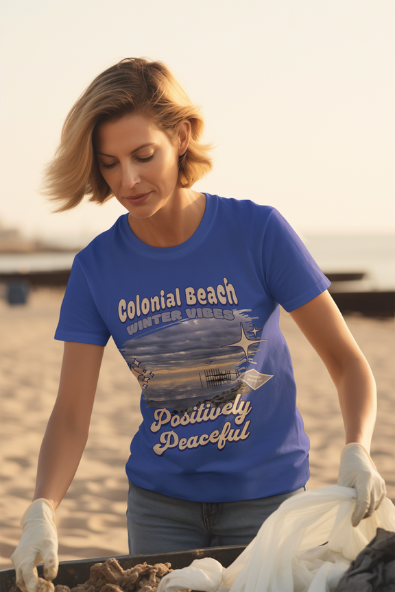 woman wearing colonial beach winter vibes royal blue premium t-shirt during beach cleanup