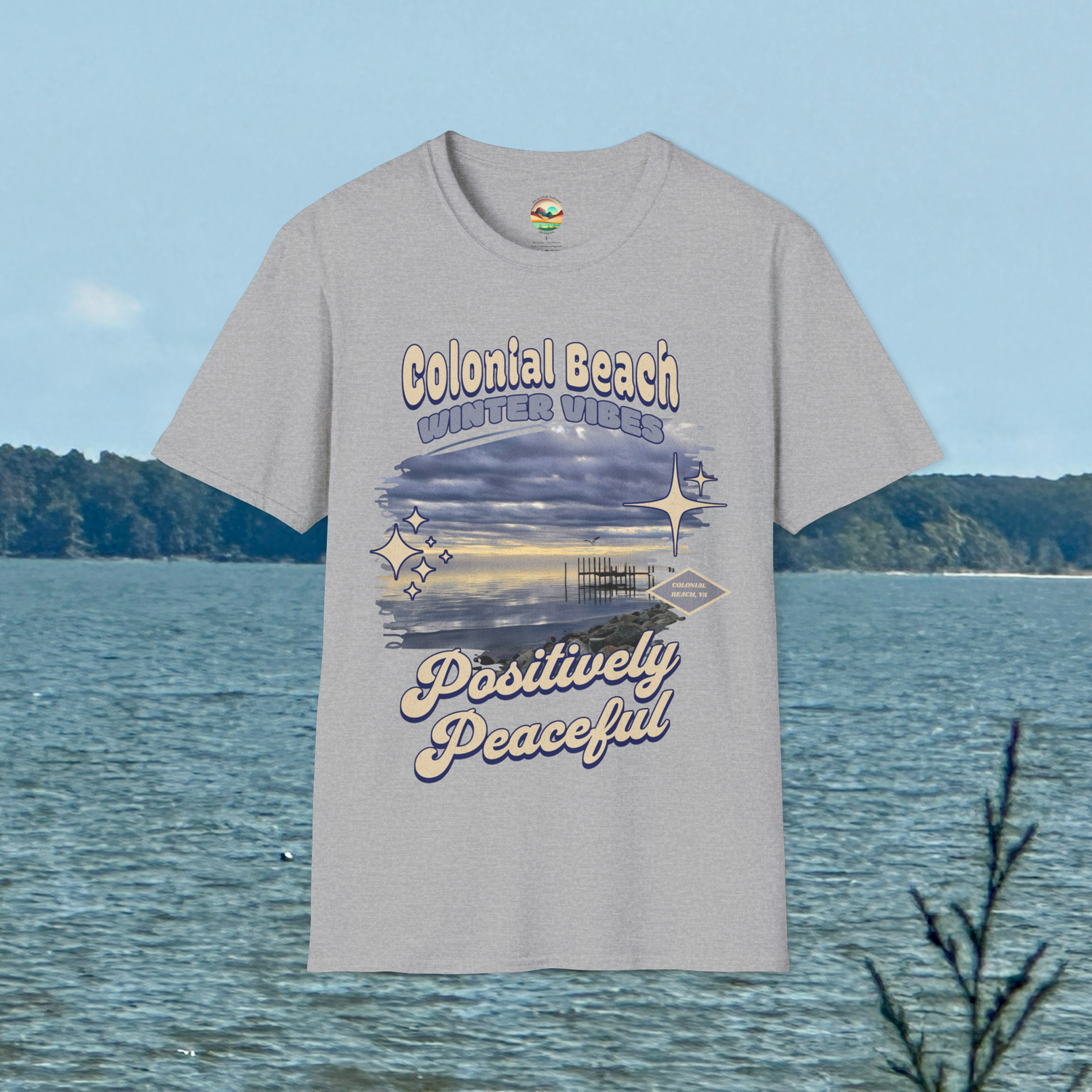 Colonial Beach Winter Vibes Soft Fit T-Shirt in Sport Grey, hanging by a peaceful beach scene