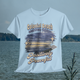 Colonial Beach Winter Vibes light blue t-shirt hanging with calm ocean backdrop