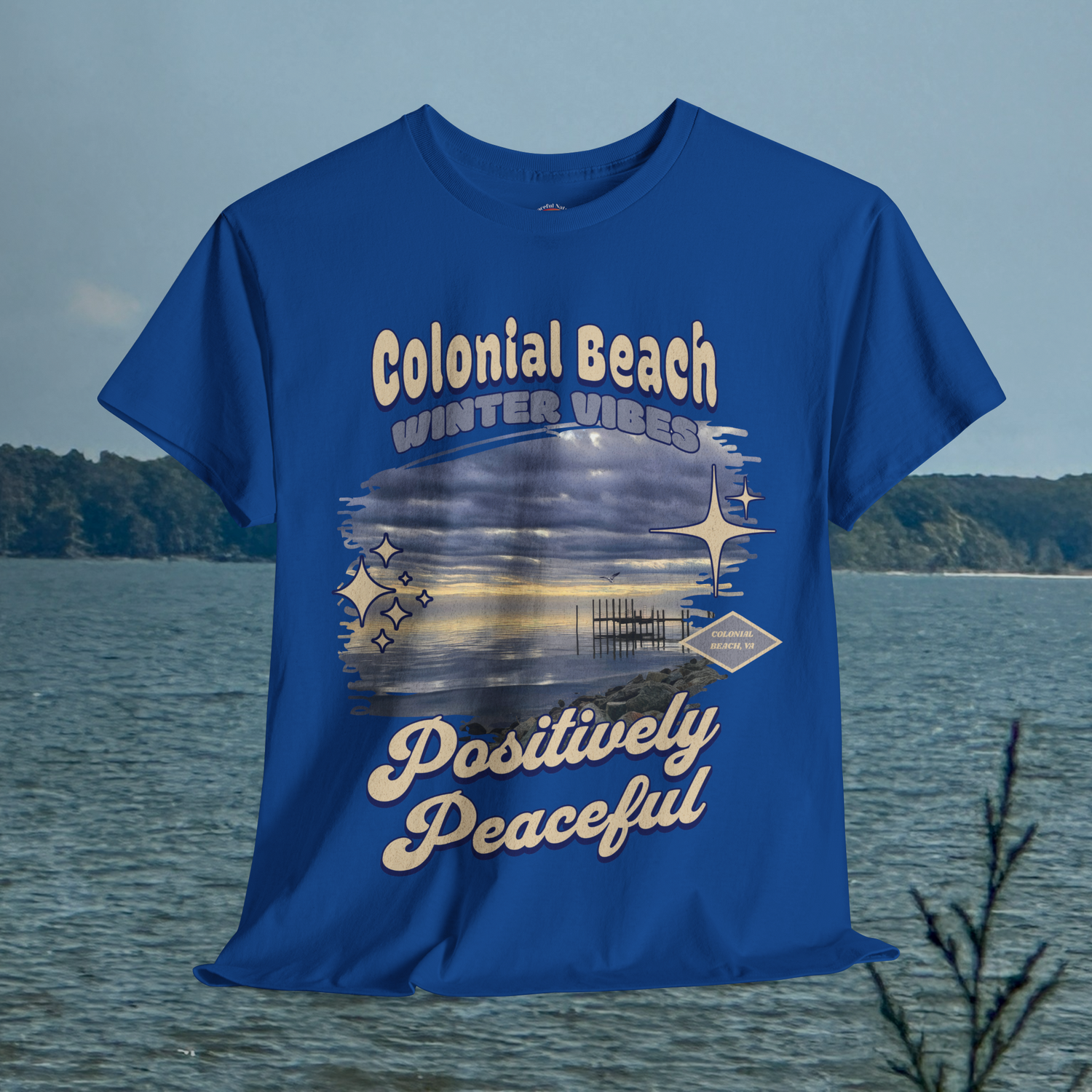 Colonial Beach Winter Vibes royal blue t-shirt hanging with peaceful beach background