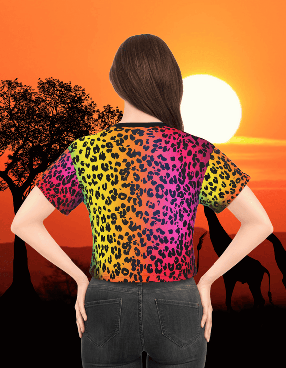 Back view of a woman showing The Colorful Leopard Crop Top featuring a vibrant rainbow leopard print pattern, styled in front of a sunset savanna background