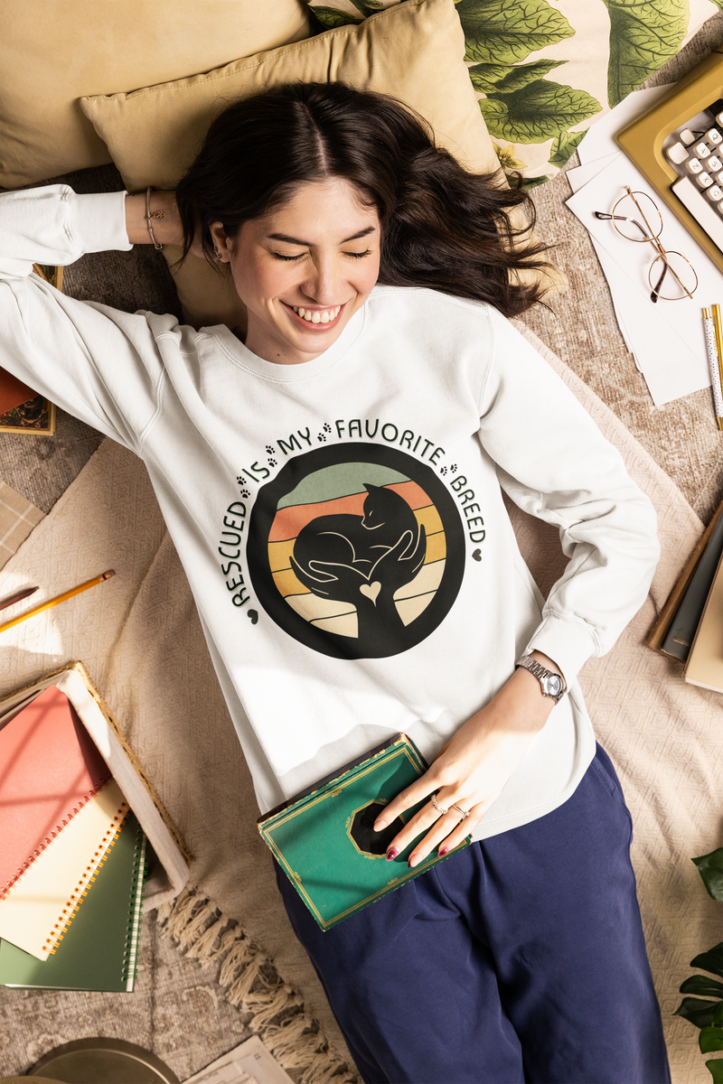 Model wearing white Comfort Colors 1566 sweatshirt with ‘Rescued Is My Favorite Breed’ design for pet lovers