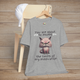 Heather grey funny cranky cat t-shirt featuring angry cartoon cat illustration and sarcastic medication limits quote, laid flat on chair, perfect for cat lovers