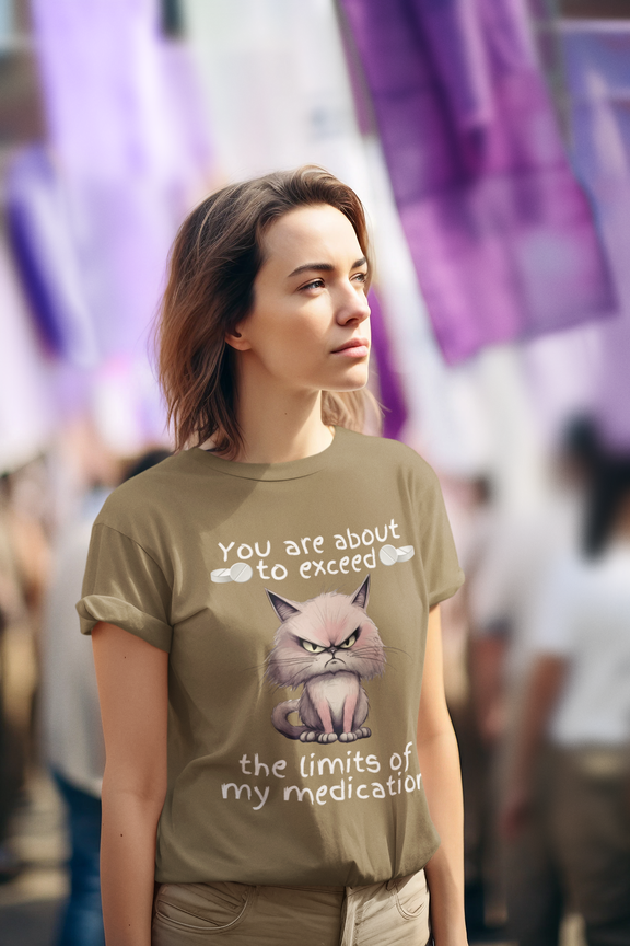 Woman standing outdoors wearing sarcastic heather olive cranky cat t-shirt with angry cartoon cat and funny quote about medication, perfect for cat moms
