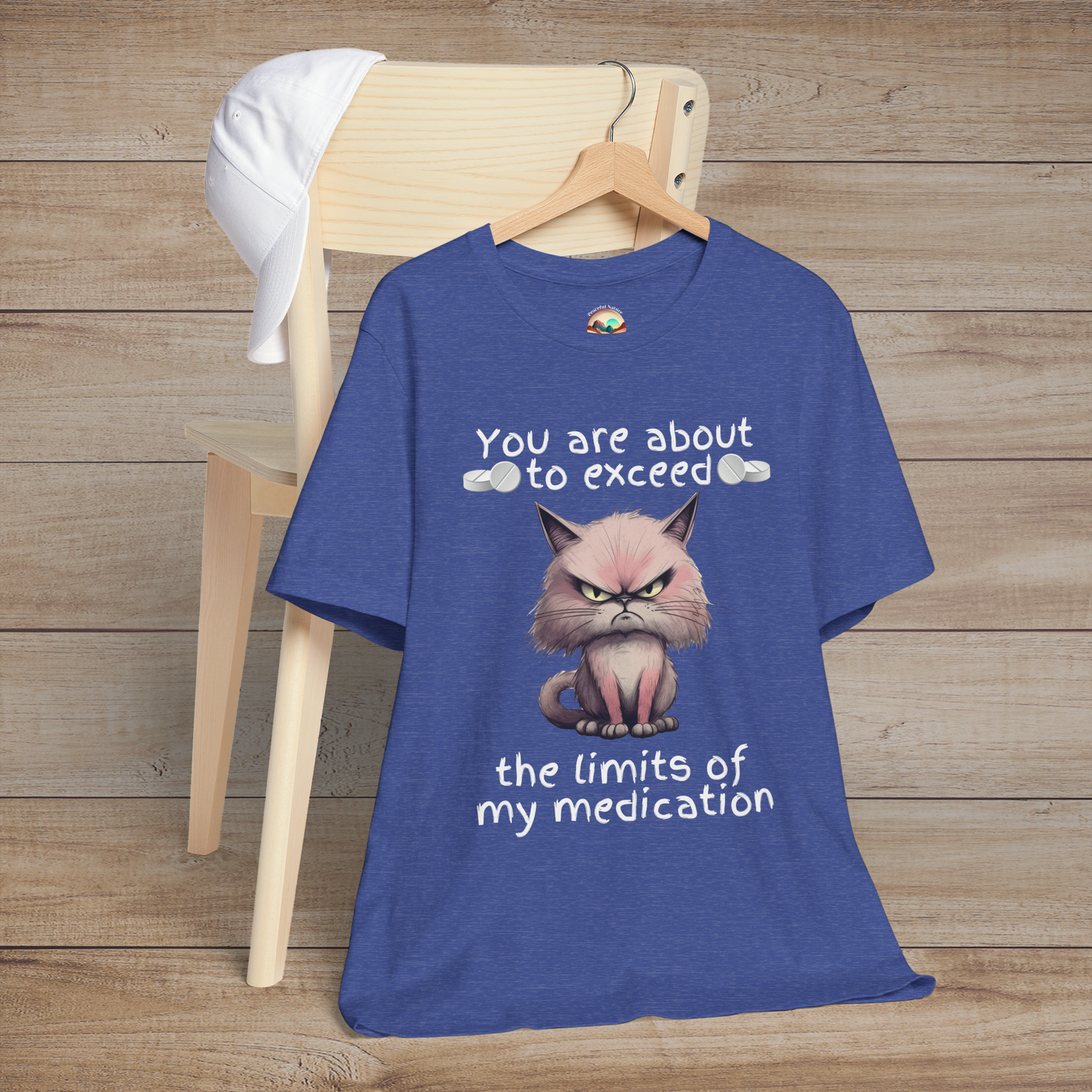 Heather royal blue cranky cat t-shirt with grumpy cartoon cat graphic and sarcastic medication humor quote, laid flat, ideal for cat lovers and humor fans