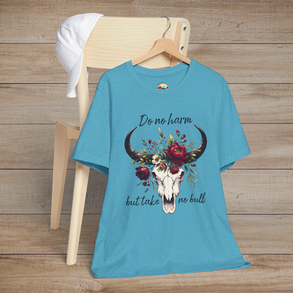 Flat lay of "Do No Harm But Take No Bull" t-shirt in heather aqua with bull skull and floral crown