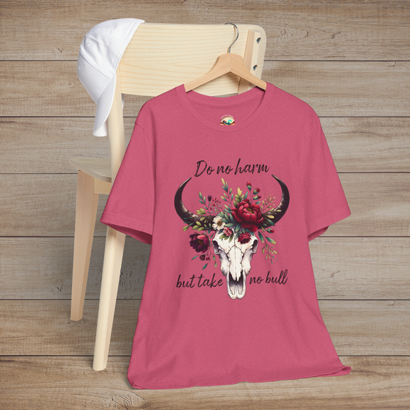 Flat lay of "Do No Harm But Take No Bull" t-shirt in heather raspberry with bull skull and floral crown