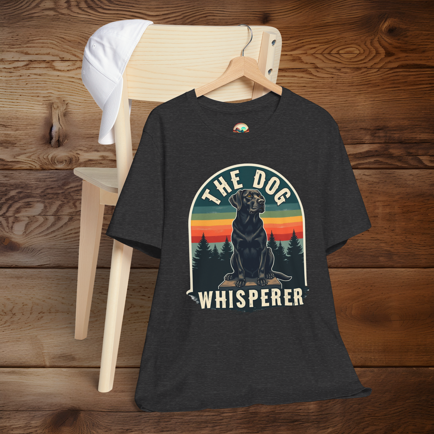 Dark grey "The Dog Whisperer" t-shirt featuring black dog and retro rainbow background