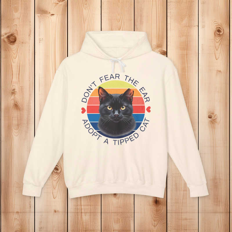 Flatlay of an ivory hoodie with the “Don’t Fear the Ear – Adopt a Tipped Cat” retro black cat rescue design.
