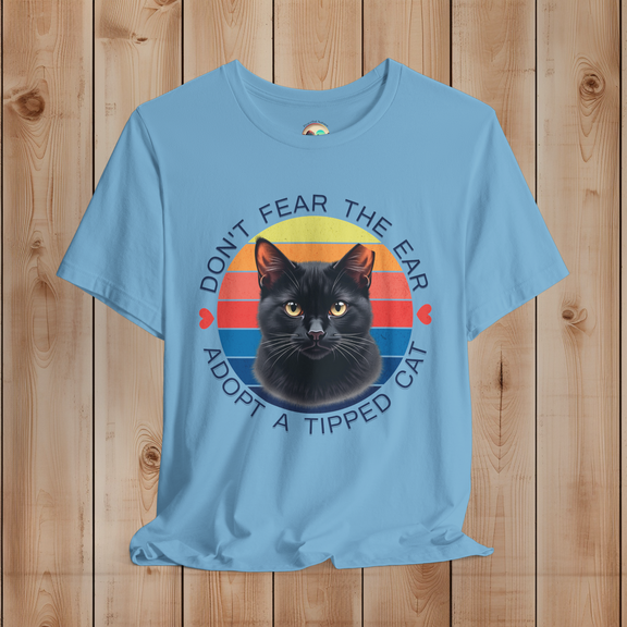 Ocean Blue Bella Canvas tee with black cat ear-tipped TNR design and colorful retro stripes