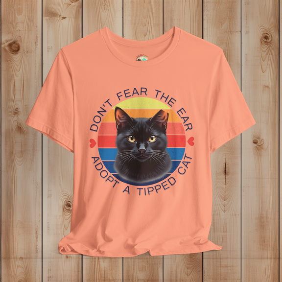 Peach Sunset Bella Canvas shirt showing a retro black cat TNR awareness graphic
