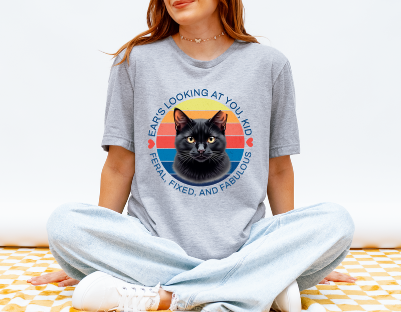 Woman wearing grey (athletic heather) Ear’s Looking at You Kid TNR cat shirt with retro ear-tipped black cat design, Bella Canvas 3001