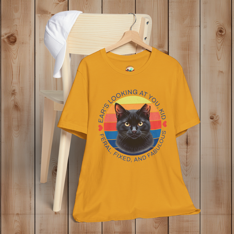 Mustard yellow Ear’s Looking at You Kid TNR cat shirt with retro ear-tipped black cat design, Bella Canvas 3001 flatlay.