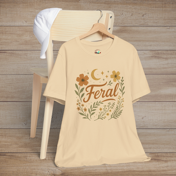 Feral t-shirt in Soft Cream with floral and moon design in elegant calligraphy, displayed on a chair with a cap
