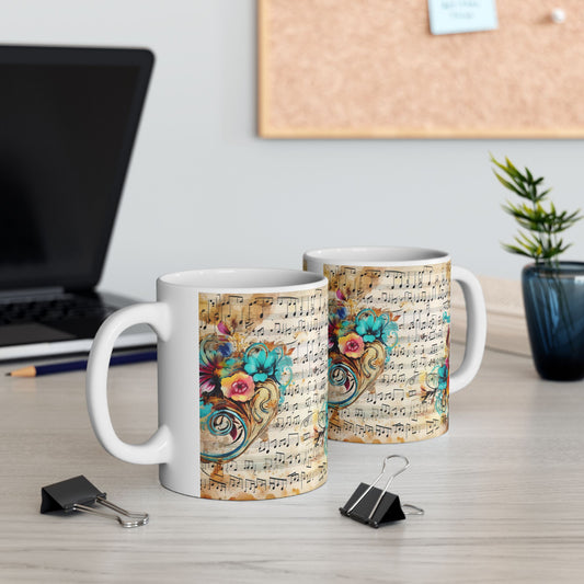 Left and right views of two 11 oz Floral Melody Mugs on a modern office desk, both featuring colorful flowers and graceful musical notation. A stylish coffee mug for musicians, teachers, and creatives