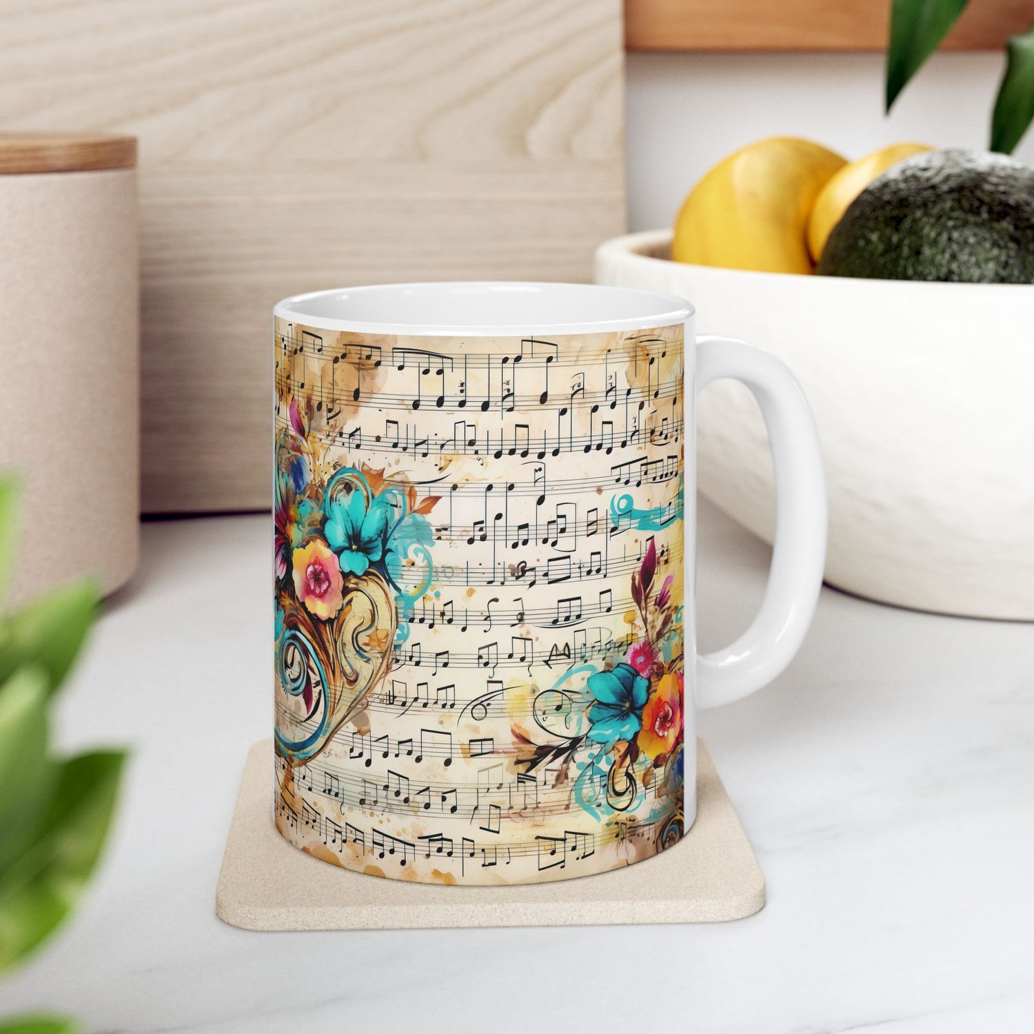 Right-side view of the 11 oz Floral Melody Mug in a cozy kitchen space, displaying vibrant aqua and orange flowers swirling around sheet music on antique parchment. Perfect mug for music and flower lovers