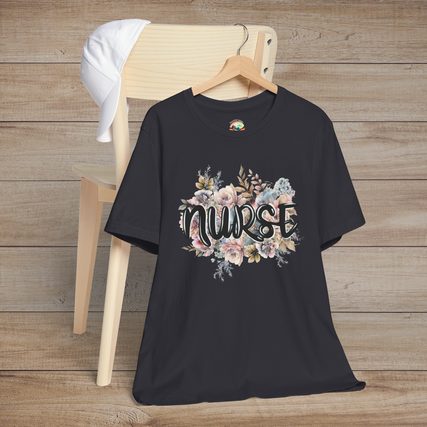 Dark grey Nurse Floral Premium Fit T-Shirt on hanger, decorated with delicate pastel floral bouquet and stylish nurse lettering