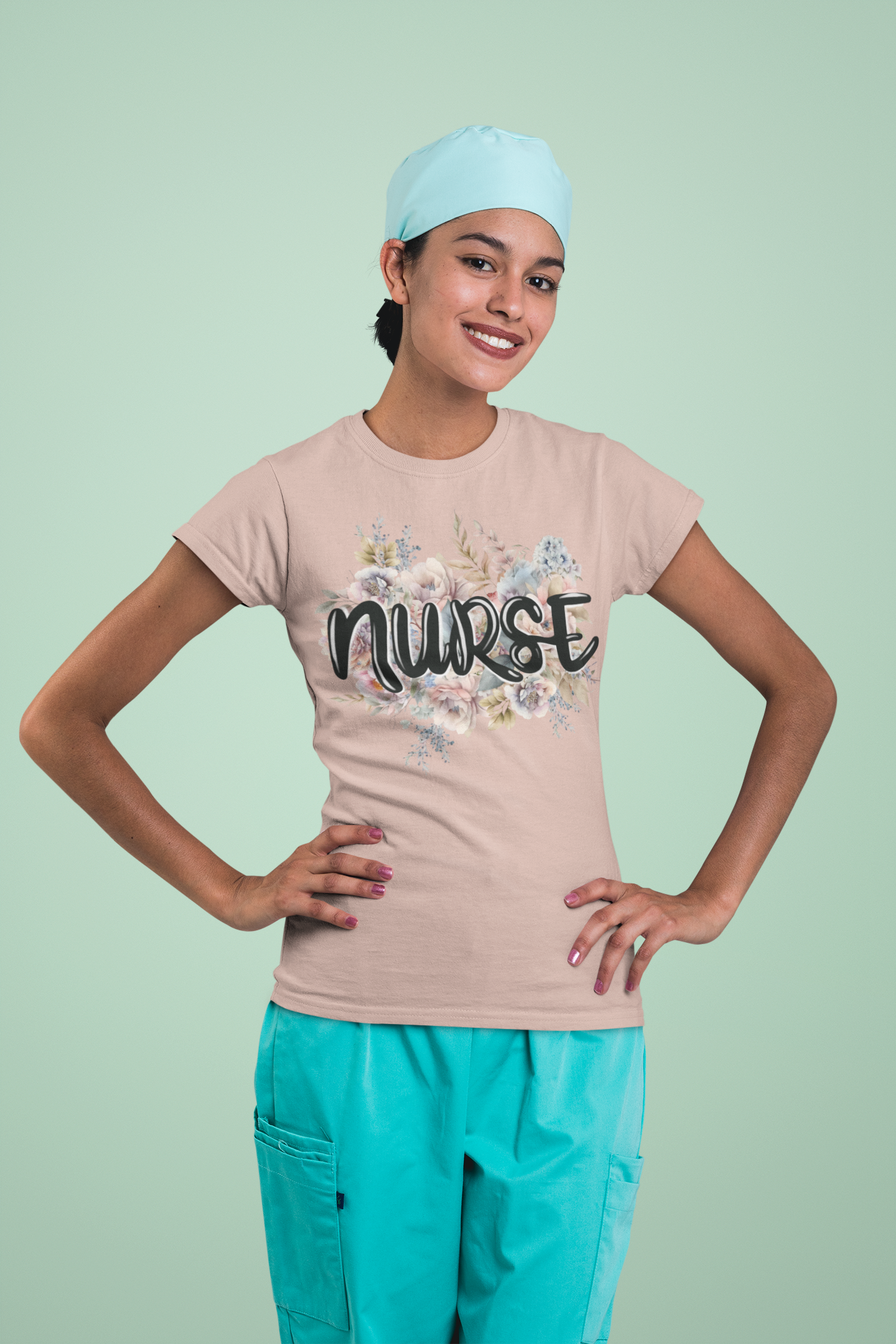 Cheerful woman in medical attire modeling the heather prism peach Nurse Floral Premium Fit T-Shirt, emphasizing its delicate pastel floral and elegant nurse text