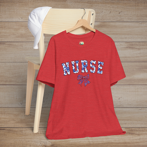 Heather red t-shirt displayed on a hanger over a chair, with bold 'NURSE' floral lettering and a decorative bow – perfect for fashionable nurses