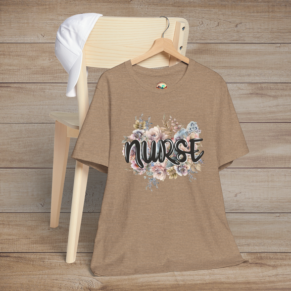 Heather tan Nurse Floral Premium Fit T-Shirt presented on hanger, showcasing pastel floral pattern and bold, elegant lettering