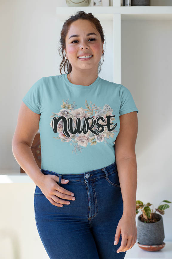 Warm, smiling woman modeling turquoise Nurse Floral Premium Fit T-Shirt indoors, highlighting the subtle elegance of the pastel floral and nurse-themed design